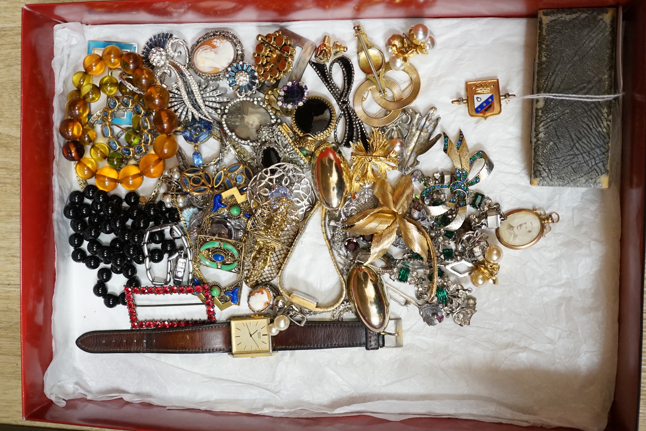 A large collection of costume jewellery, including a green and clear paste set necklace, a jet necklace, a silver and citrine cloak brooch, a yellow metal framed double portrait pendant, a yellow metal, enamel and rose c